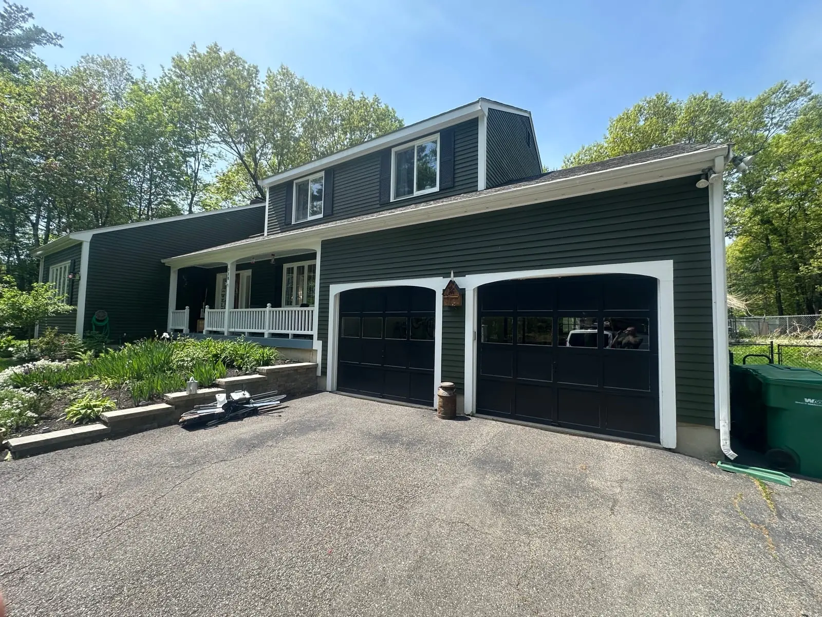Original aging double garage doors on a Massachusetts home before replacement